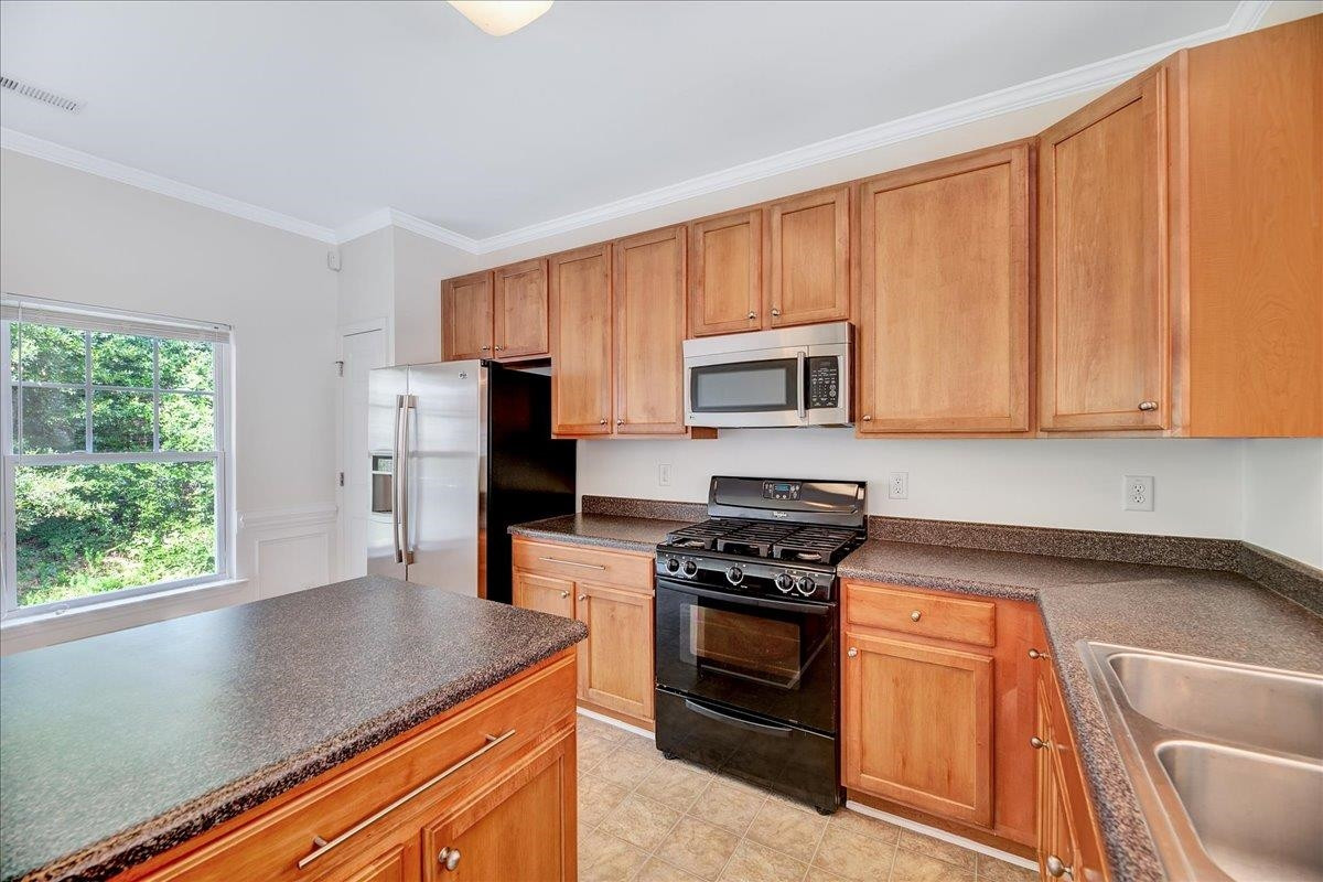 11838 Canemount Street Raleigh, NC 27614 - Photo 12 of 34 a kitchen with stainless steel appliances granite countertop a stove a sink and a microwave