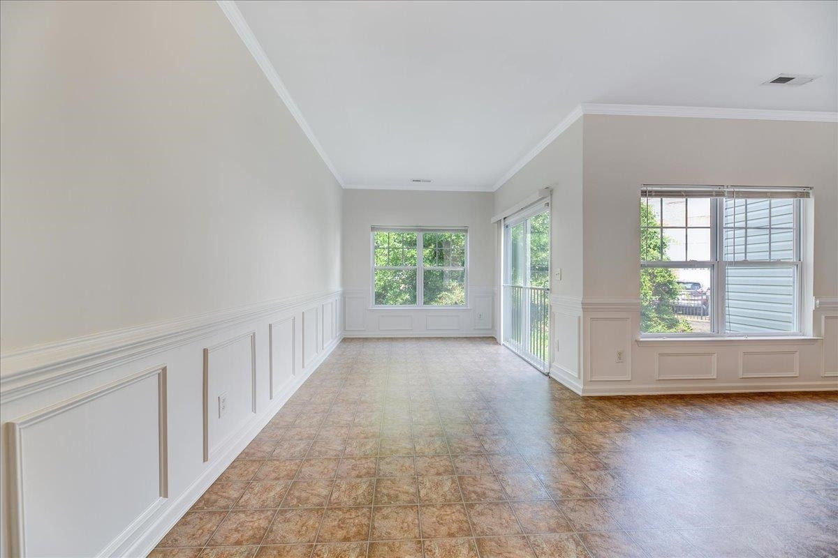 11838 Canemount Street Raleigh, NC 27614 - Photo 13 of 34 an empty room with wooden floor and windows