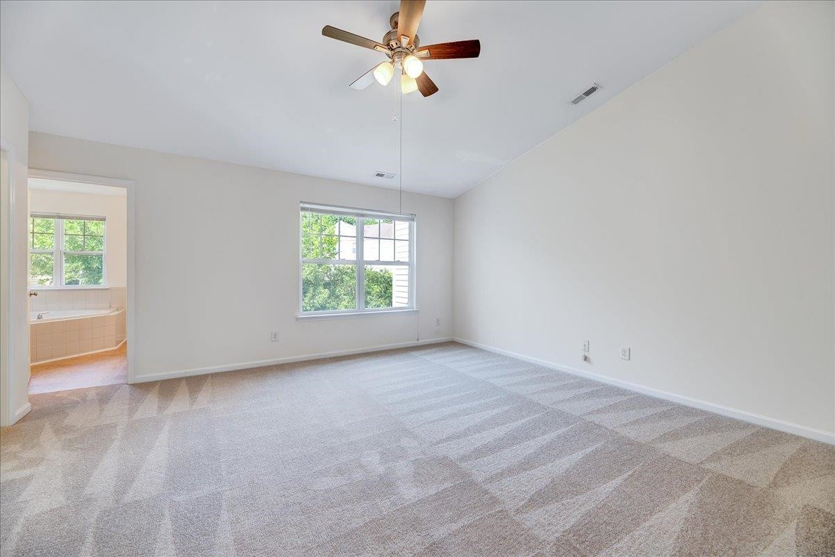 11838 Canemount Street Raleigh, NC 27614 - Photo 16 of 34 an empty room with windows and ceiling fan