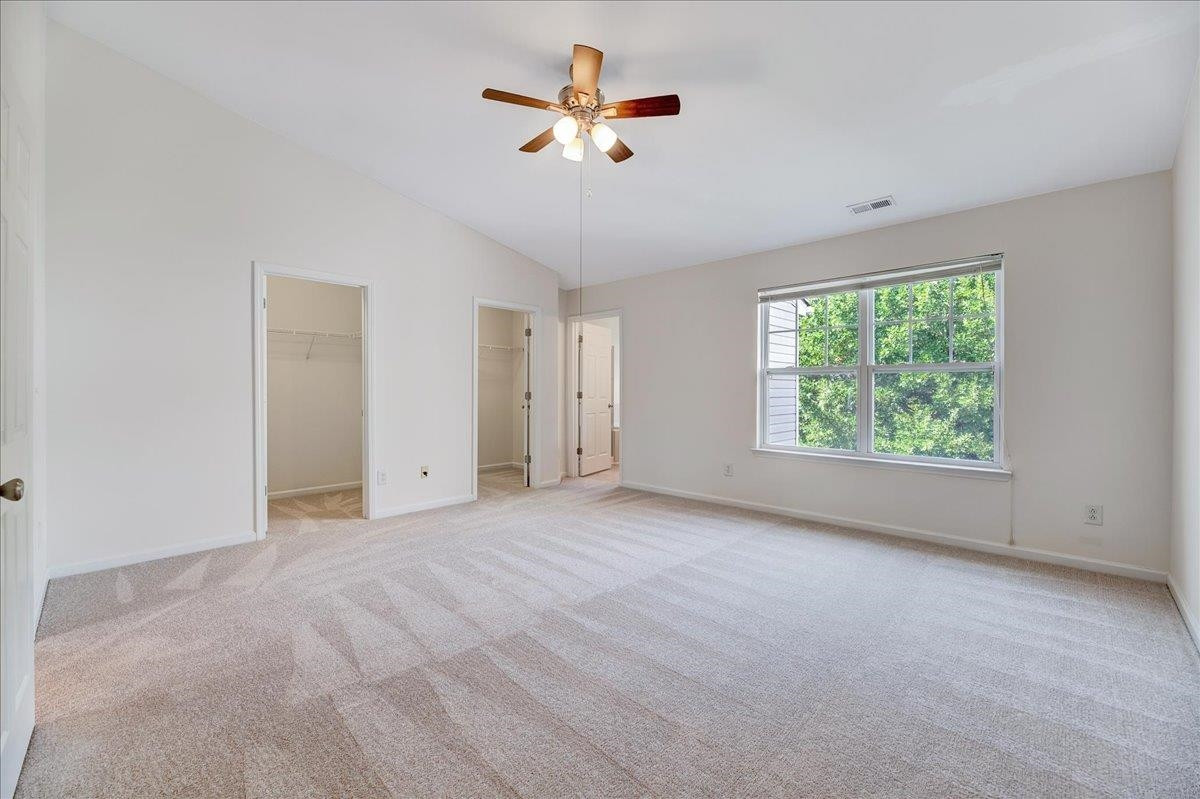 11838 Canemount Street Raleigh, NC 27614 - Photo 17 of 34 an empty room with ceiling fan and windows
