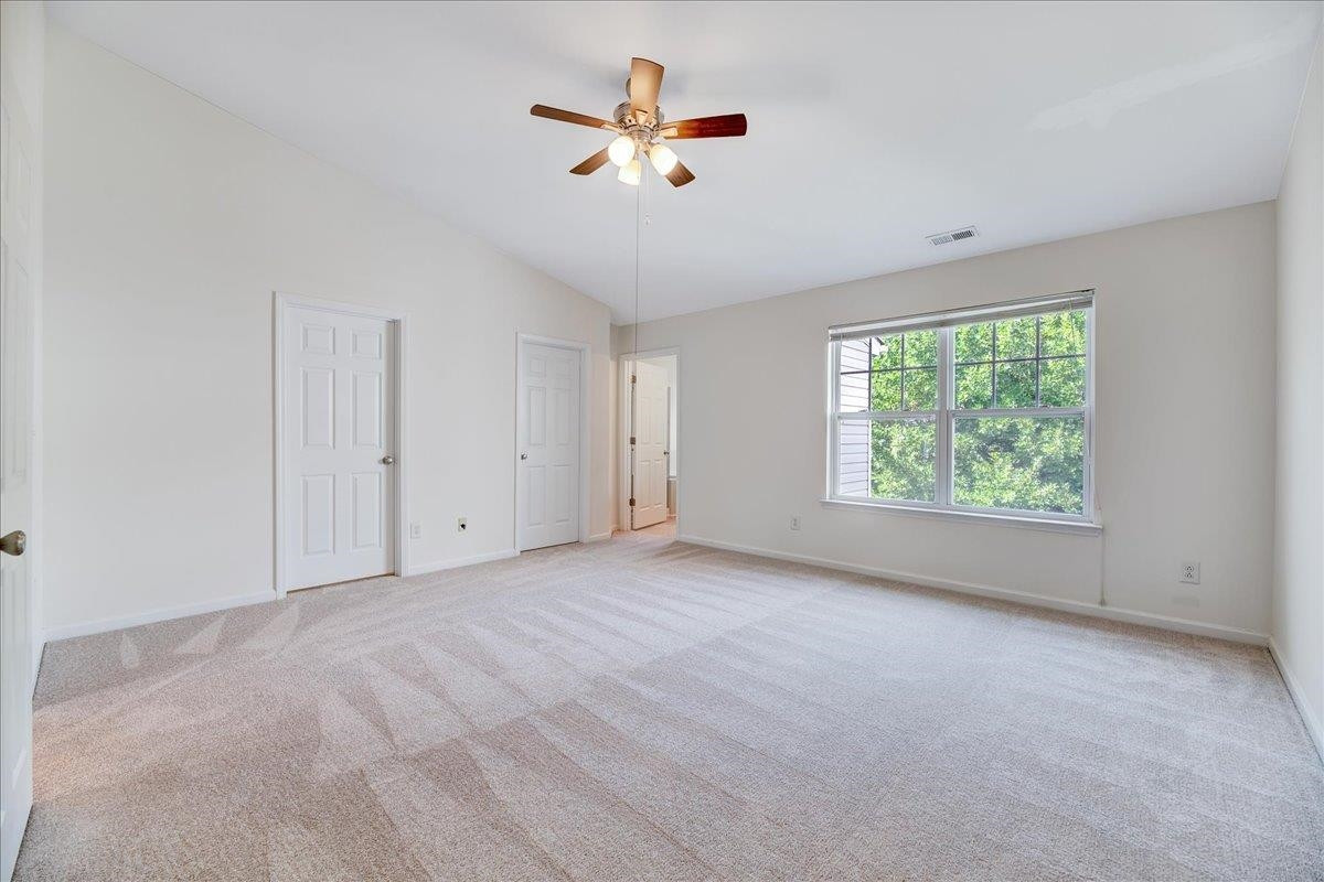11838 Canemount Street Raleigh, NC 27614 - Photo 19 of 34 an empty room with ceiling fan and windows