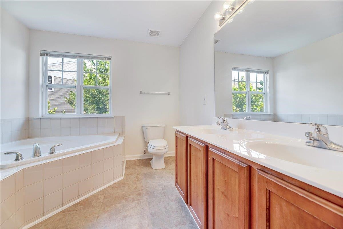 11838 Canemount Street Raleigh, NC 27614 - Photo 20 of 34 a spacious bathroom with a tub sink and mirror