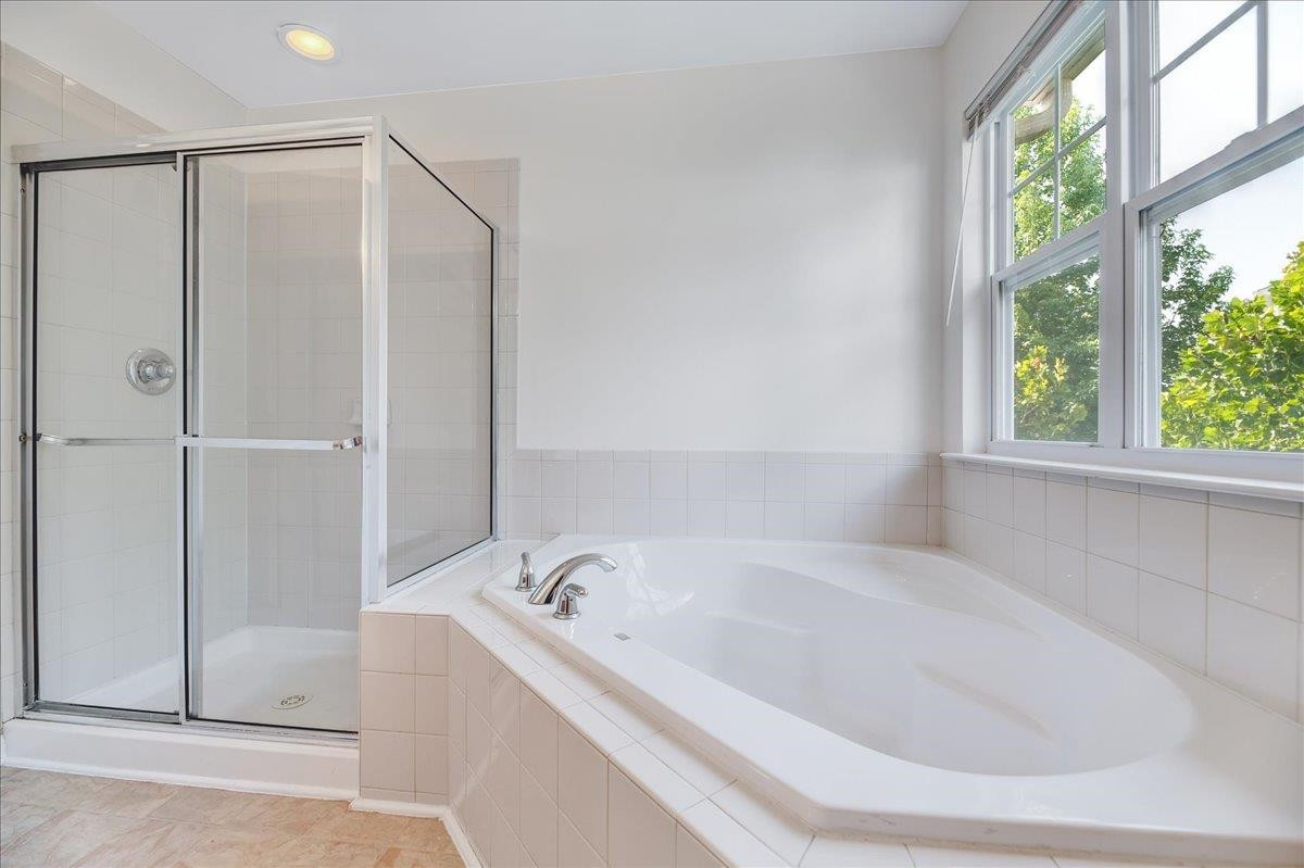 11838 Canemount Street Raleigh, NC 27614 - Photo 21 of 34 a bathroom with a bathtub and a shower