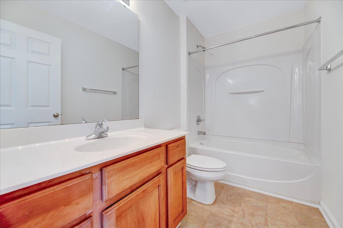 11838 Canemount Street Raleigh, NC 27614 - Photo 27 of 34 a bathroom with a sink a toilet and a large mirror