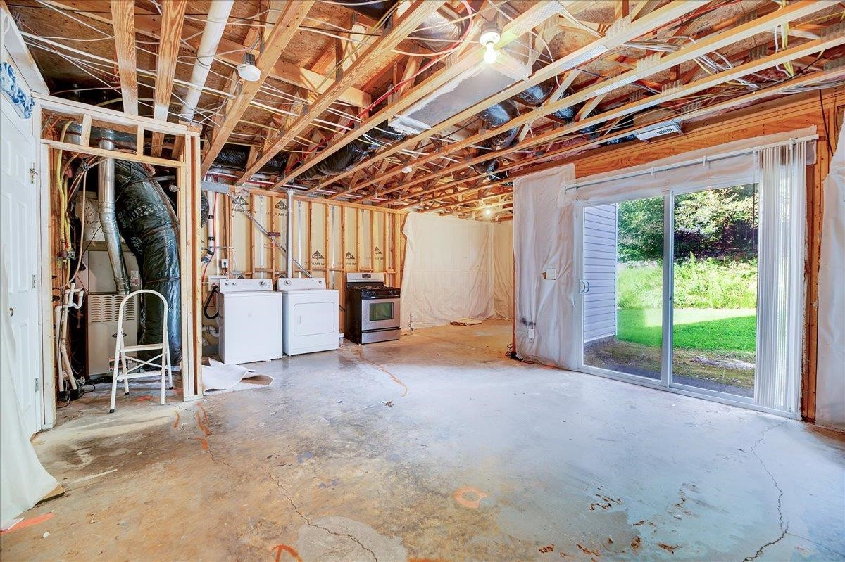 11838 Canemount Street Raleigh, NC 27614 - Photo 28 of 34 a view of an empty room with floor to ceiling windows and stairs