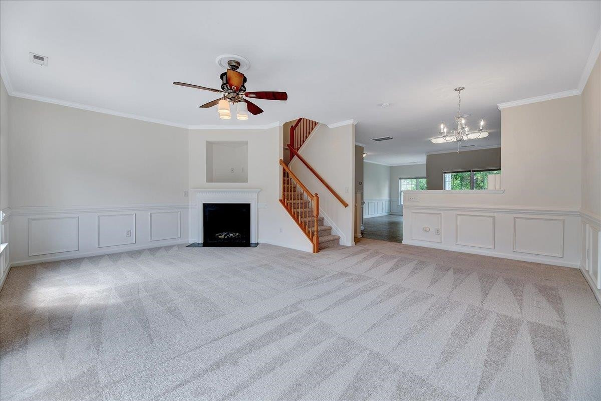 11838 Canemount Street Raleigh, NC 27614 - Photo 4 of 34 a view of a livingroom with wooden floor and a ceiling fan
