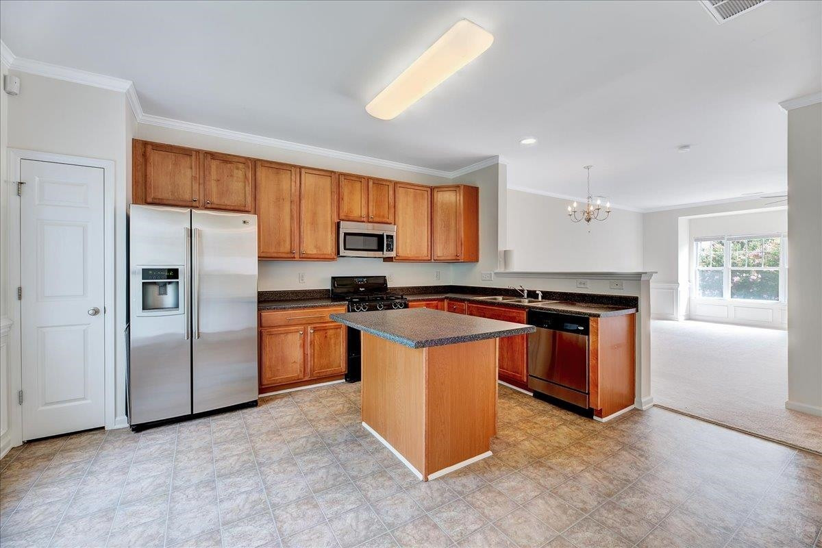 11838 Canemount Street Raleigh, NC 27614 - Photo 7 of 34 a kitchen with stainless steel appliances granite countertop a stove a refrigerator a sink a stove and a microwave