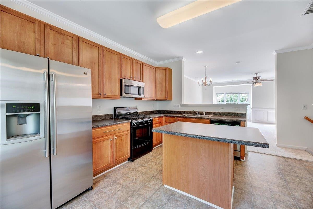11838 Canemount Street Raleigh, NC 27614 - Photo 10 of 34 a kitchen with stainless steel appliances granite countertop a refrigerator a stove and a sink
