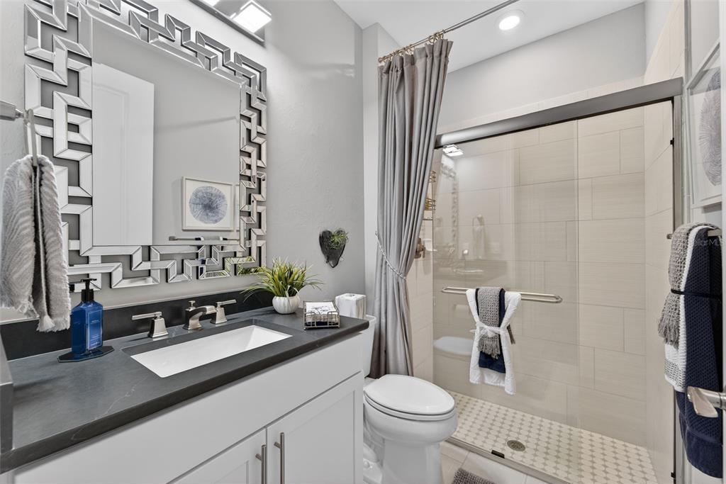 1721 Hyssop Loop North Port, FL 34289 - Photo 21 of 70 a bathroom with a sink toilet double vanity and shower