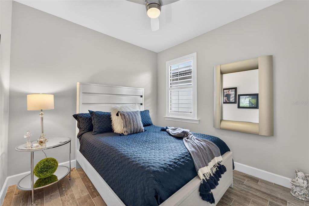 1721 Hyssop Loop North Port, FL 34289 - Photo 22 of 70 a bedroom with a bed a window and potted plant