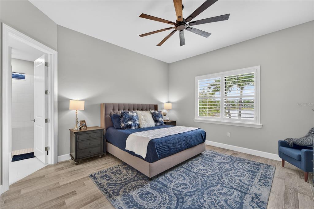 1721 Hyssop Loop North Port, FL 34289 - Photo 27 of 70 a bedroom with a large bed and a window