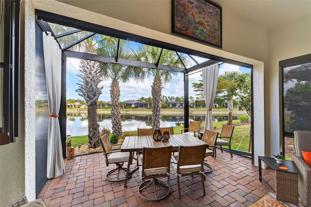 1721 Hyssop Loop North Port, FL 34289 - Photo 38 of 70 a dining room with furniture water view and a floor to ceiling window