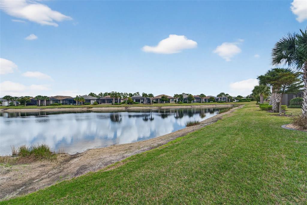 1721 Hyssop Loop North Port, FL 34289 - Photo 40 of 70 a view of a lake with houses in the back