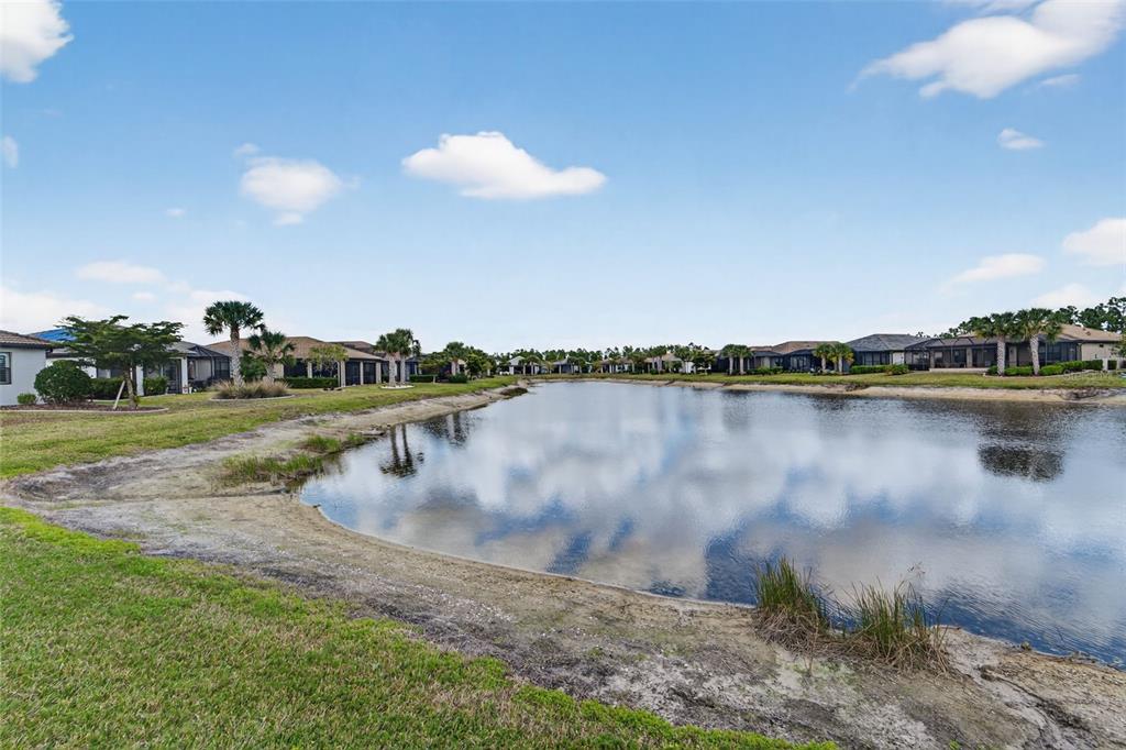 1721 Hyssop Loop North Port, FL 34289 - Photo 43 of 70 a view of a lake with houses in the back