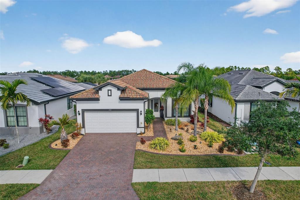 1721 Hyssop Loop North Port, FL 34289 - Photo 48 of 70 a front view of a house with a yard and garage
