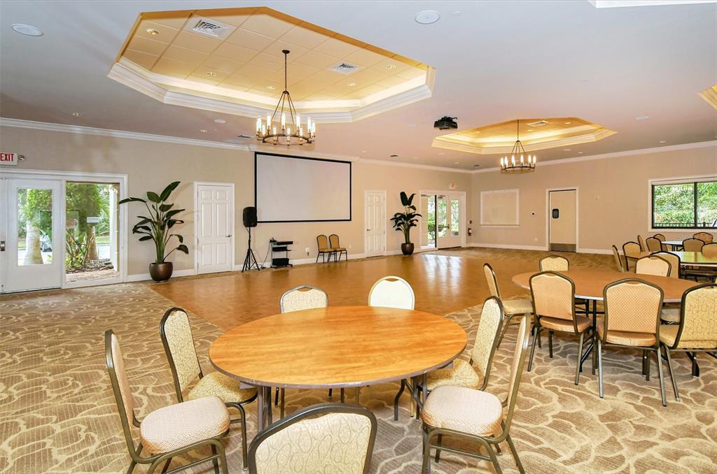 1721 Hyssop Loop North Port, FL 34289 - Photo 53 of 70 a dining room with furniture and a chandelier