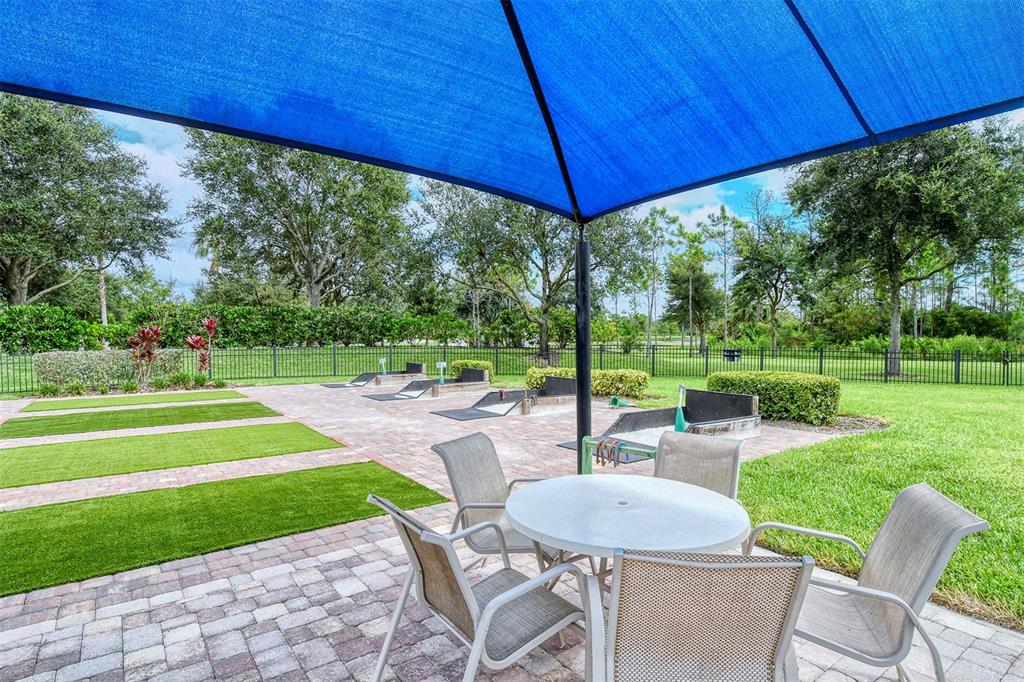 1721 Hyssop Loop North Port, FL 34289 - Photo 63 of 70 a view of a chair and table in the yard