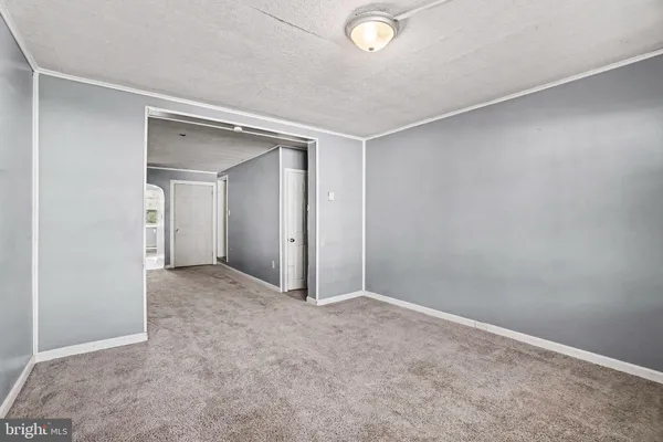 an empty room with closet and mirror