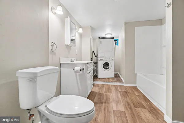 a white toilet sitting next to a bathroom sink and tub