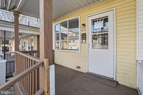 an entrance view of a house and wooden deck
