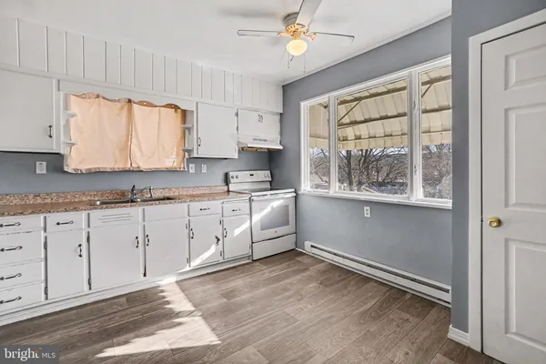 a large white kitchen with window