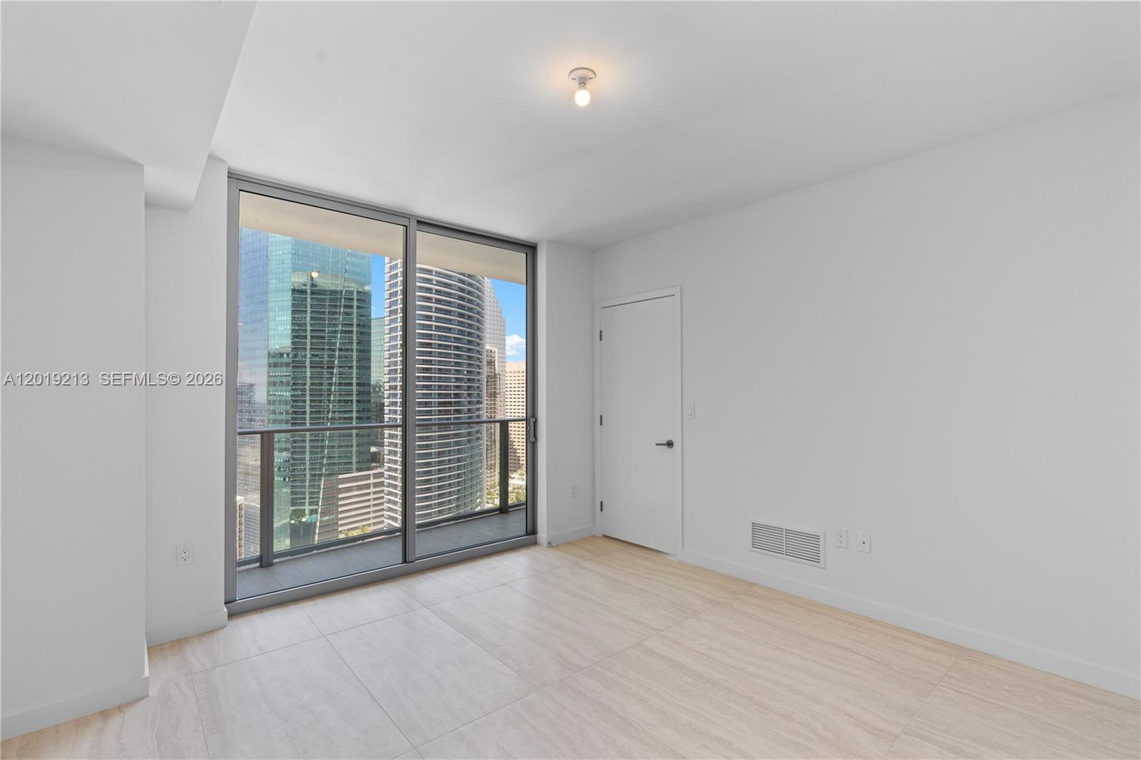 77 Southeast 5th, Unit 3702 Miami, FL 33131 - Photo 16 of 63 a view of an empty room with glass door