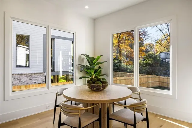 a dining room with furniture and wooden floor