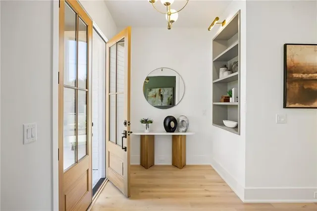 a picture of a room with wooden floor and windows