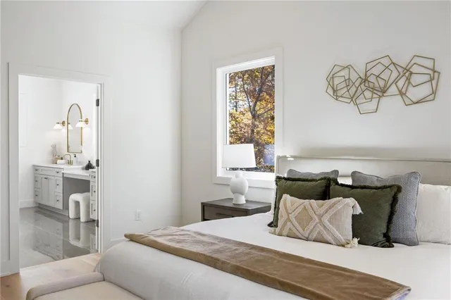 a large bathroom with a double vanity sink a mirror and a toilet