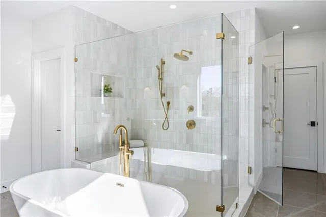 a bathroom with a tub and a shower