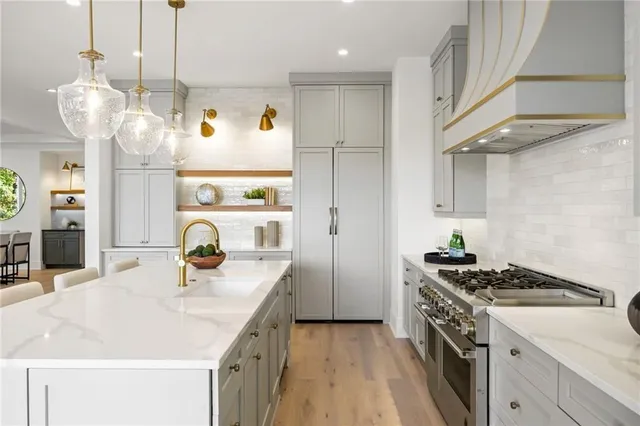 a kitchen with a sink a stove and cabinets