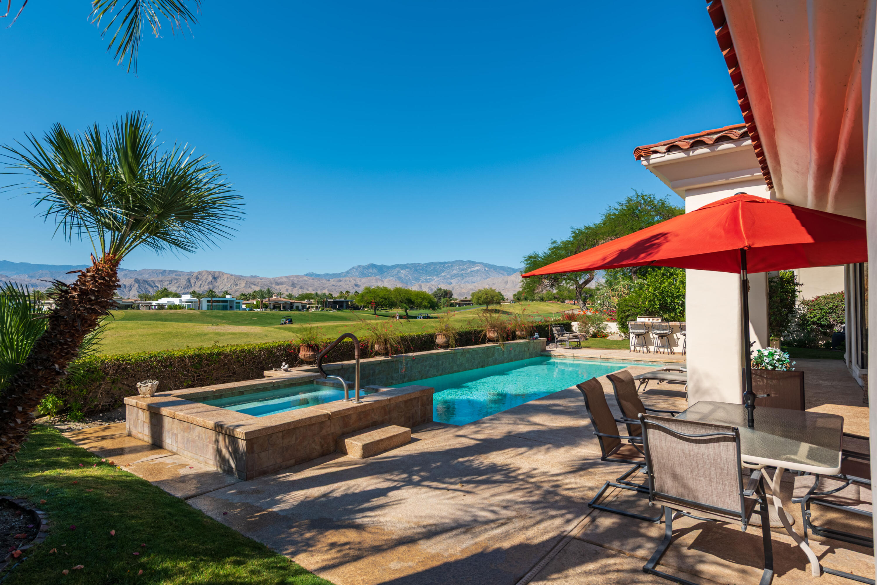 a view of a house with backyard and sitting area