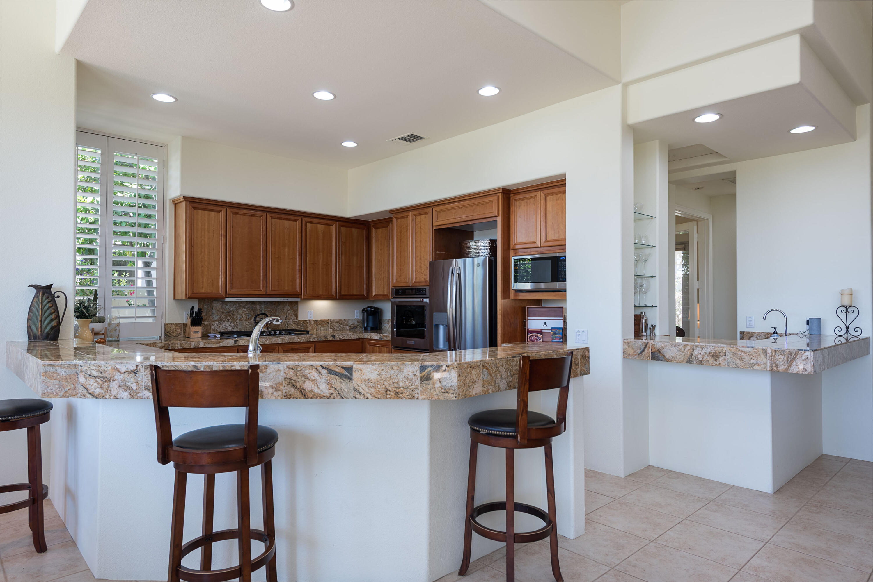 278 Loch Lomond Road Rancho Mirage, CA 92270 - Photo 21 of 49 a kitchen with stainless steel appliances granite countertop counter space a sink cabinets and stove