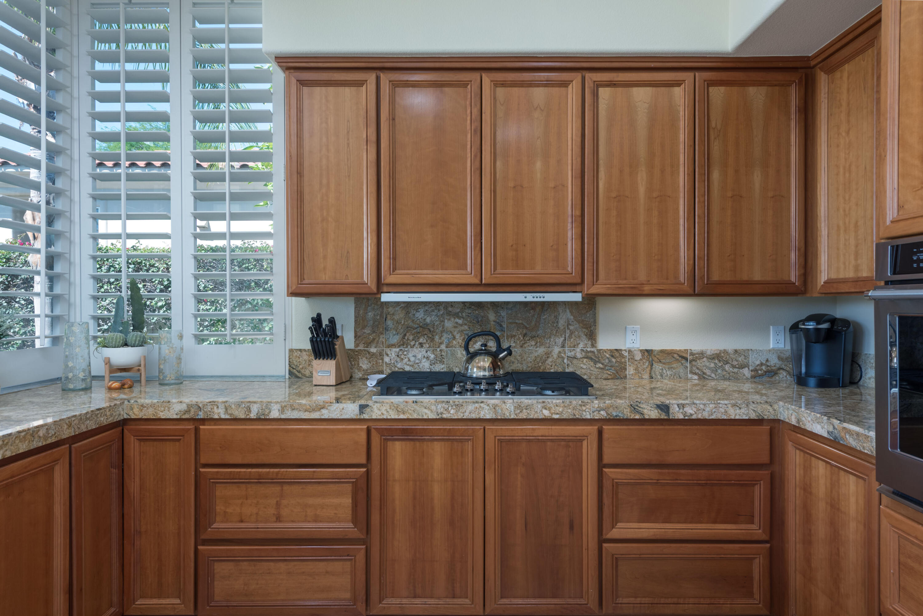 278 Loch Lomond Road Rancho Mirage, CA 92270 - Photo 24 of 49 a kitchen with granite countertop stainless steel appliances wooden cabinets and a sink