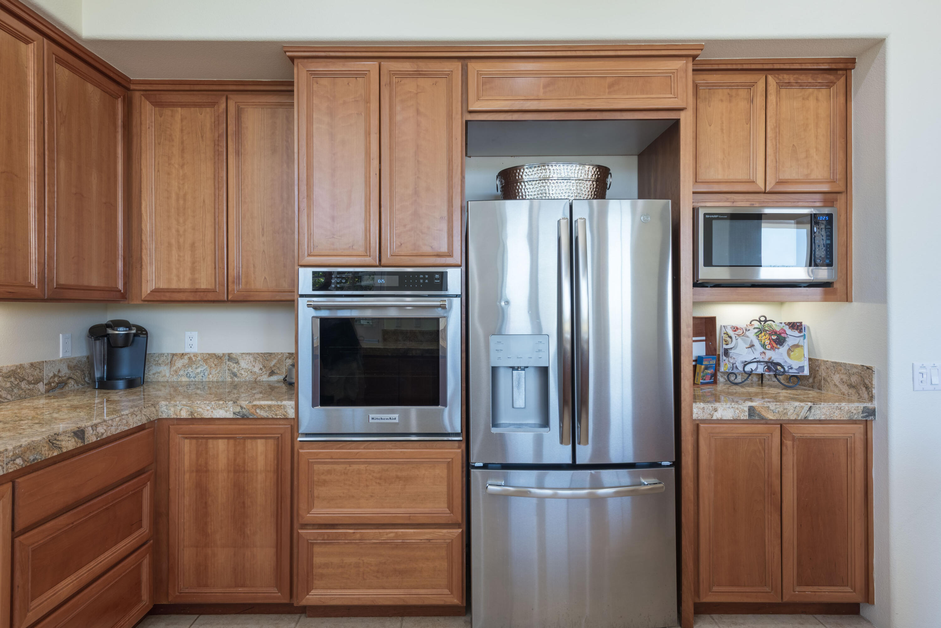 278 Loch Lomond Road Rancho Mirage, CA 92270 - Photo 25 of 49 a kitchen with granite countertop stainless steel appliances and refrigerator