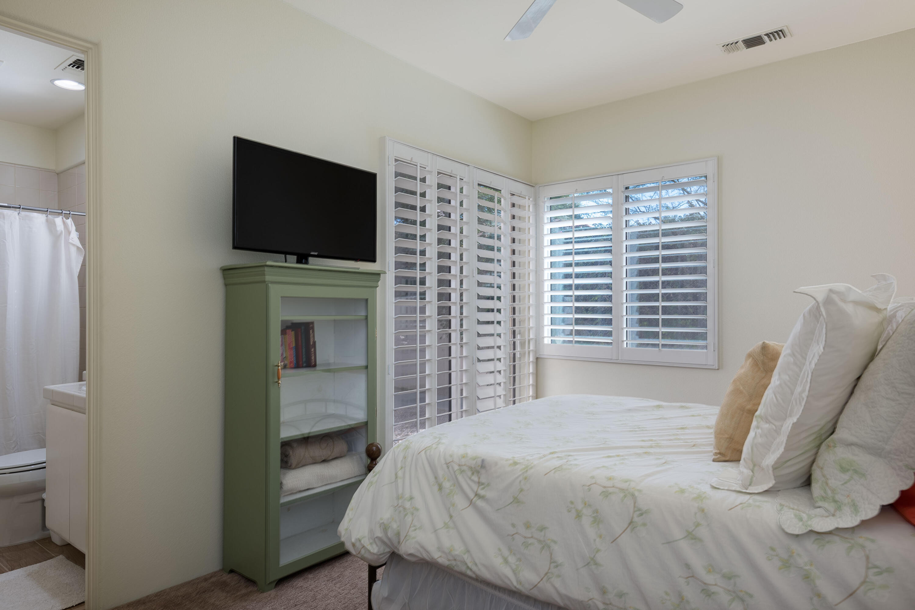 278 Loch Lomond Road Rancho Mirage, CA 92270 - Photo 34 of 49 a bedroom with a bed a television and a couch