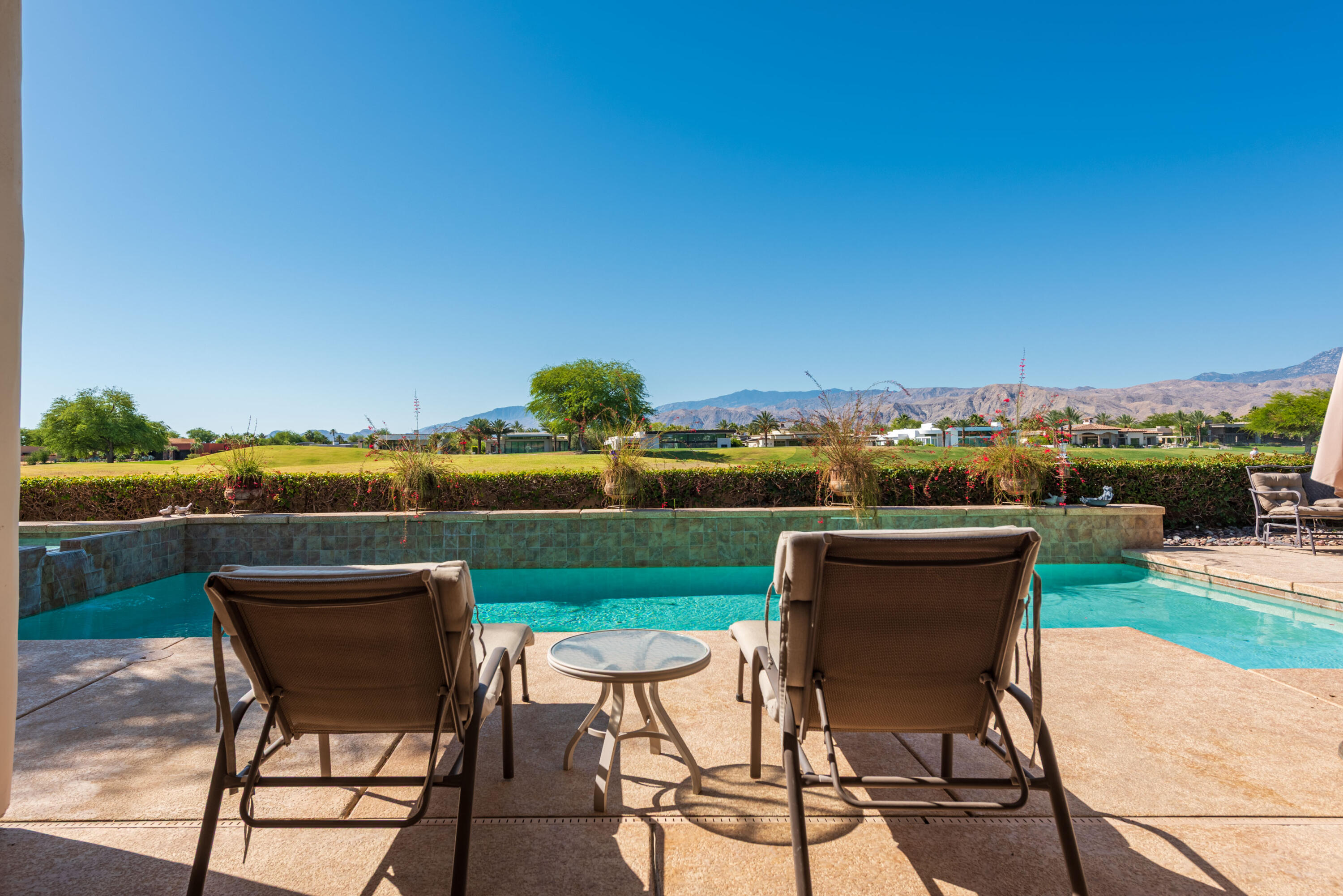 278 Loch Lomond Road Rancho Mirage, CA 92270 - Photo 41 of 49 a patio with glass top table and chairs