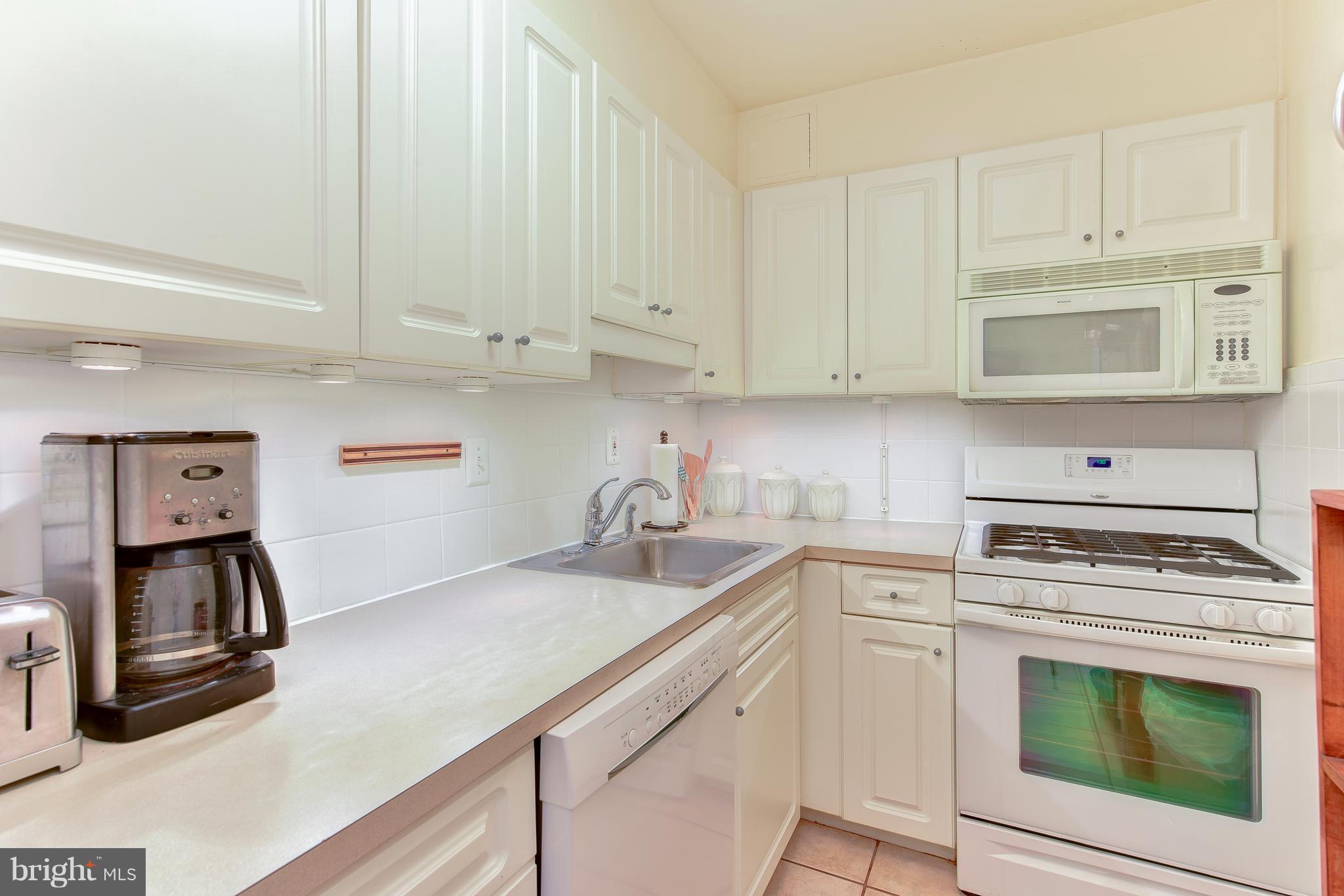1245 4th Street Southwest, Unit E607 Washington, DC 20024 - Photo 17 of 24 a kitchen with cabinets appliances and a sink