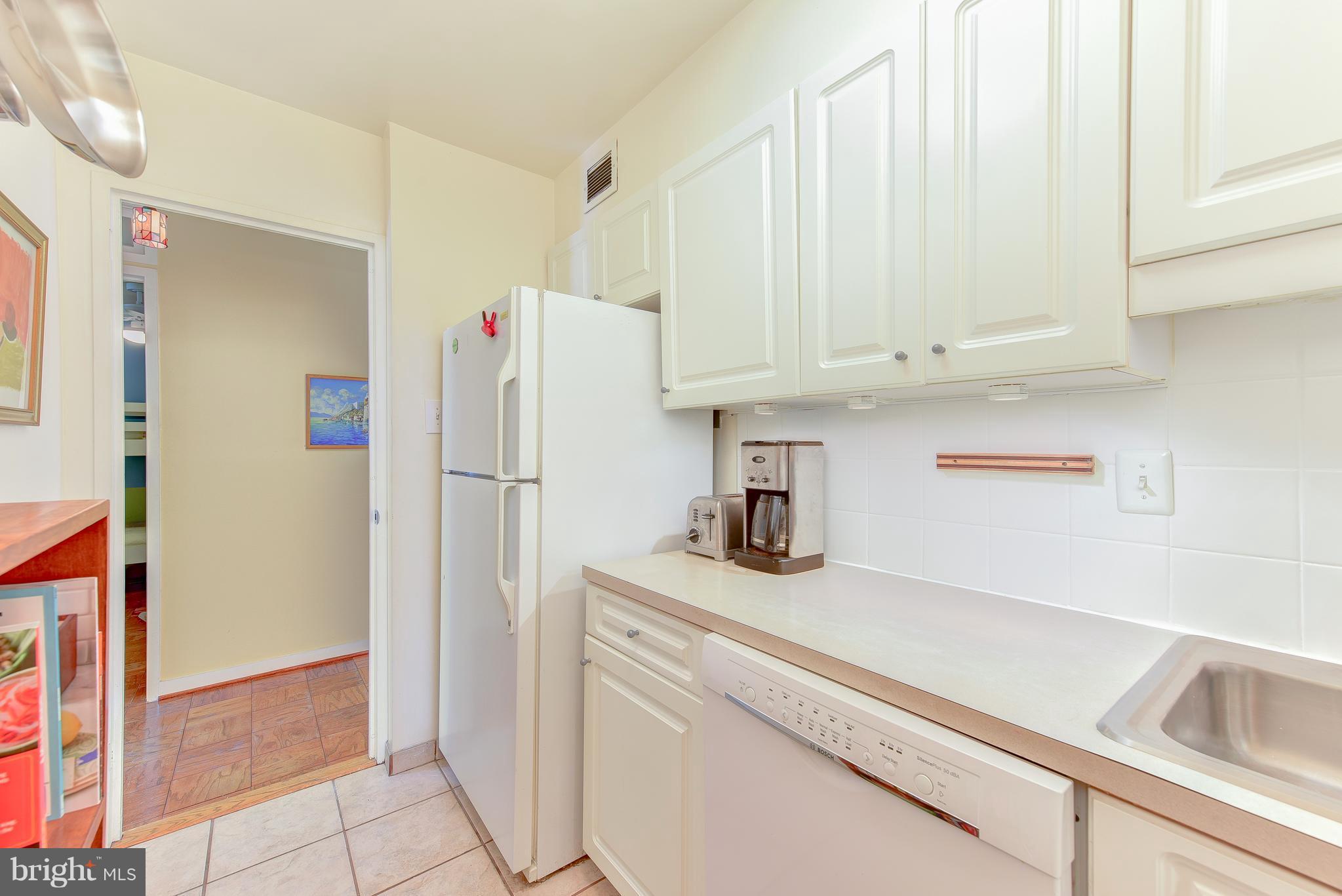 1245 4th Street Southwest, Unit E607 Washington, DC 20024 - Photo 18 of 24 a kitchen with appliances and cabinets