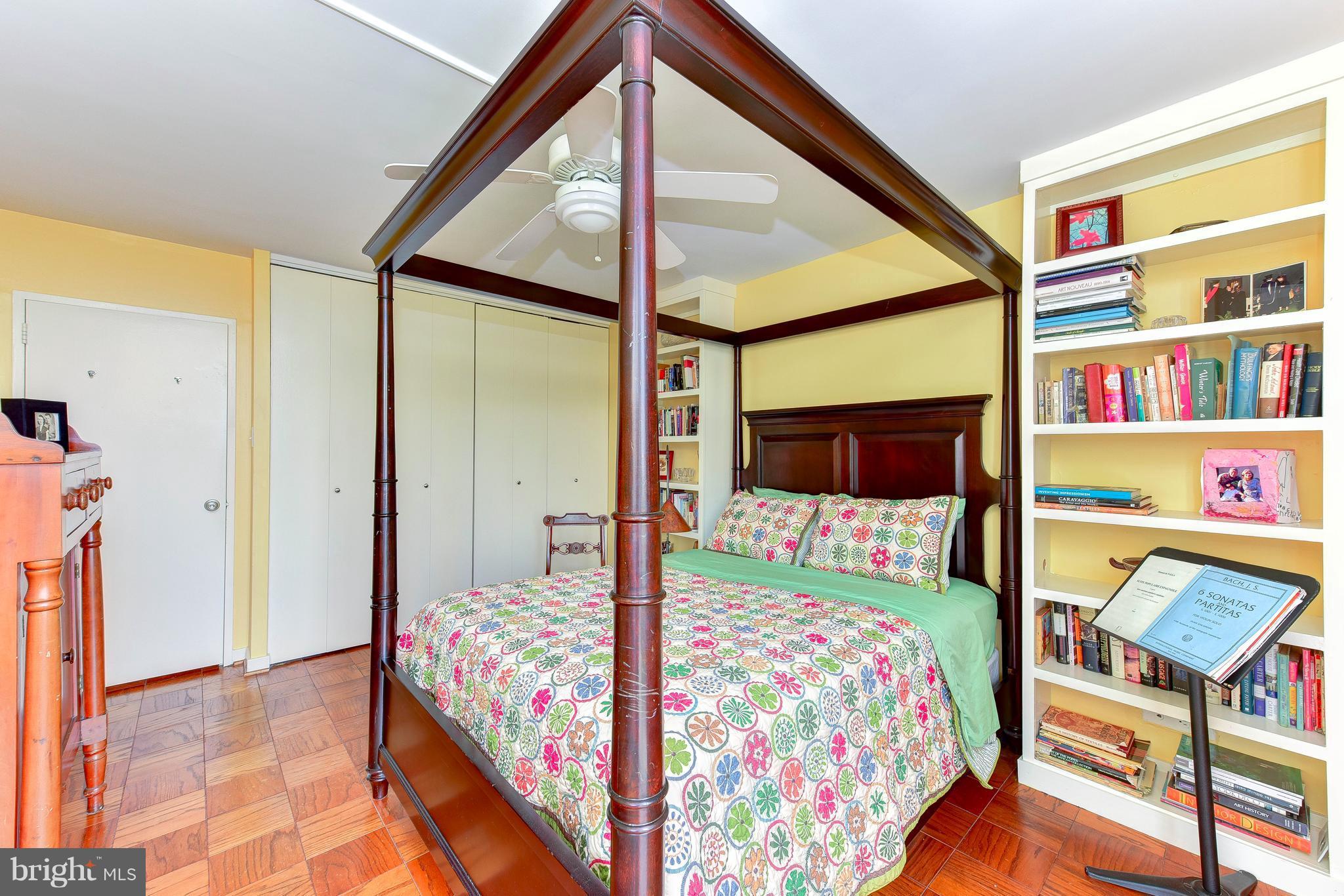1245 4th Street Southwest, Unit E607 Washington, DC 20024 - Photo 21 of 24 a bedroom with a bed and a book shelf