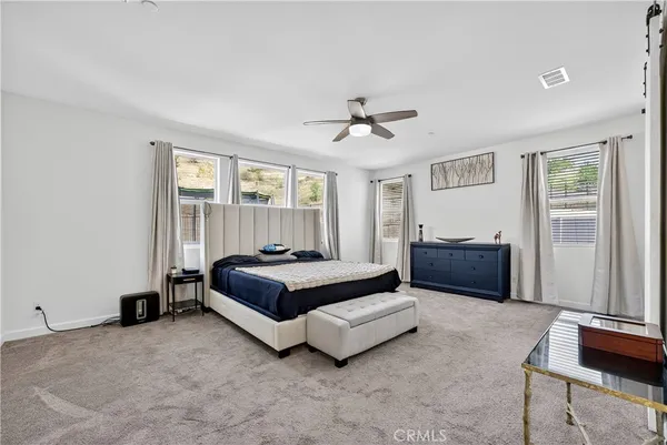 a spacious bedroom with a bed and window