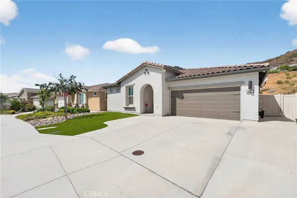 a front view of a house with a yard and garage