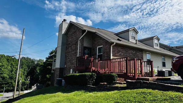 a view of a house with backyard and porch