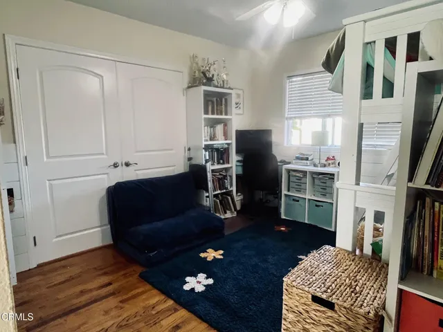 a living room with furniture rug and wooden floor