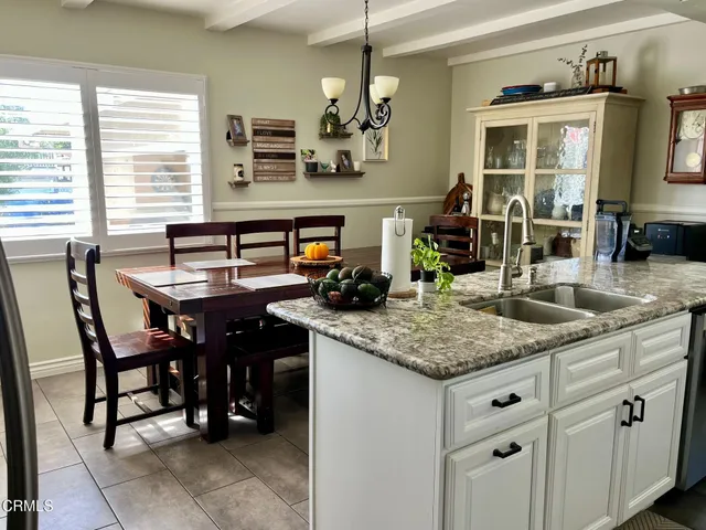 a kitchen with a counter space a sink cabinets and appliances
