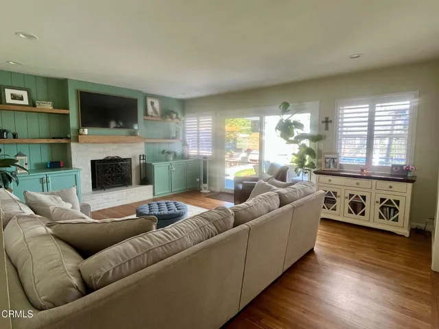 a living room with furniture a flat screen tv and a fireplace