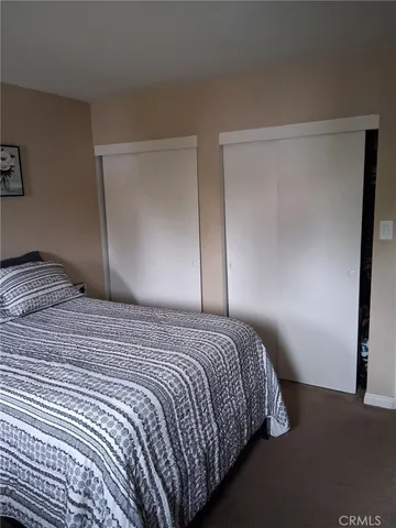 a bedroom with a bed and a mirror