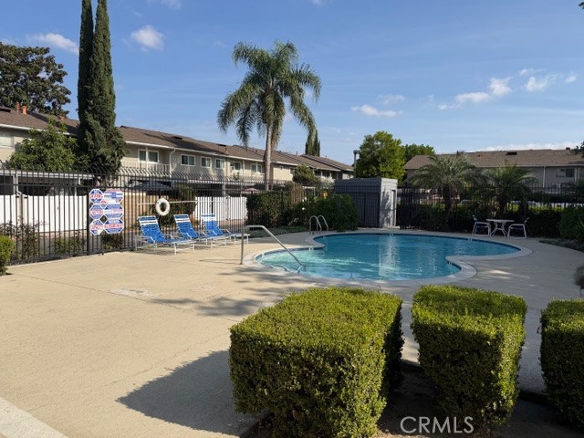 1777 Mitchell Avenue, Unit 29 Tustin, CA 92780 - Photo 24 of 26 a swimming pool with outdoor seating and yard