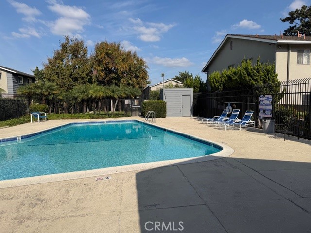 1777 Mitchell Avenue, Unit 29 Tustin, CA 92780 - Photo 26 of 26 a view of a swimming pool with some potted plants and palm trees