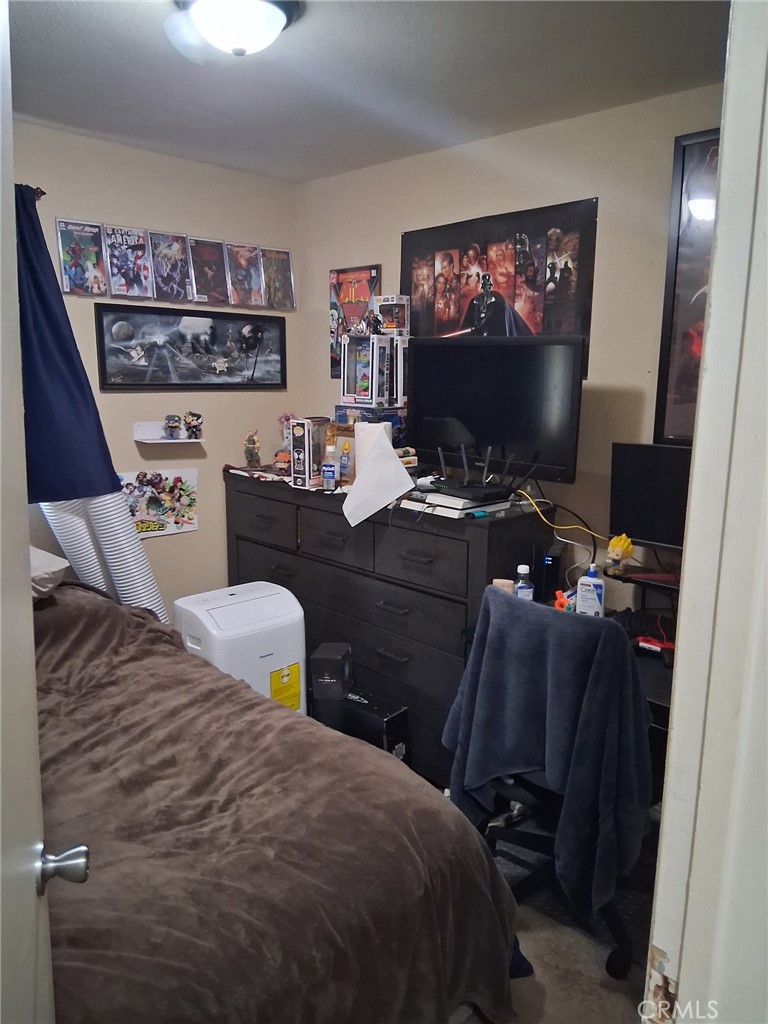 1777 Mitchell Avenue, Unit 29 Tustin, CA 92780 - Photo 9 of 26 a bedroom with a bed and a flat screen tv